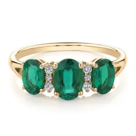 Dress ring with emerald and diamond simulants in 10 carat yellow gold