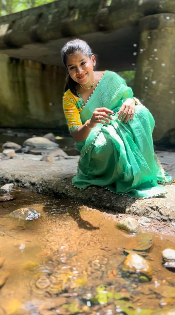 Green tissue saree with yellow floral hand worked blouse