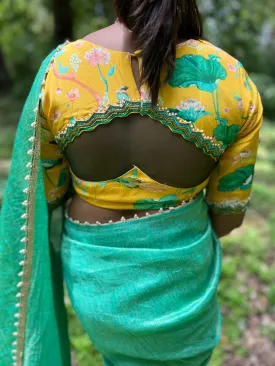 Green tissue saree with yellow floral hand worked blouse